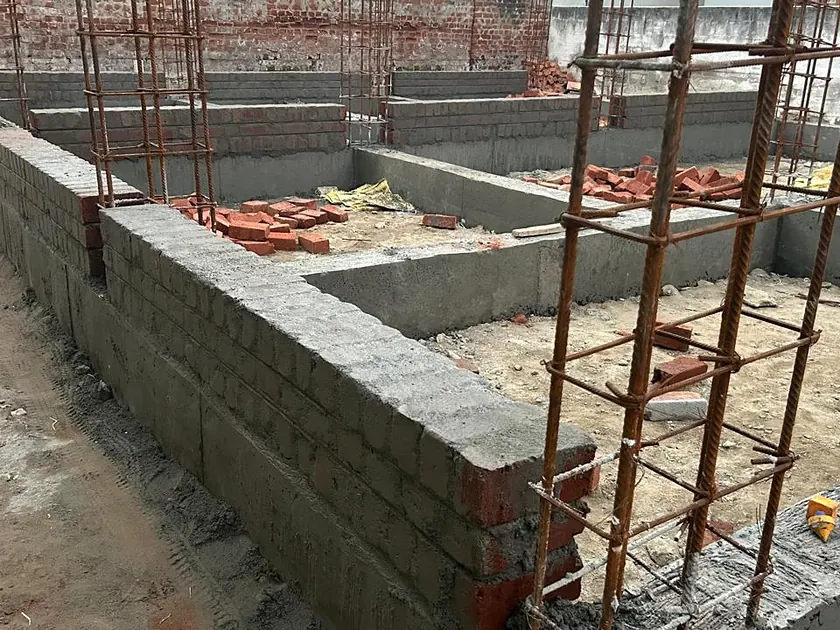 Plinth beam cast over block foundation walls with column starter bars