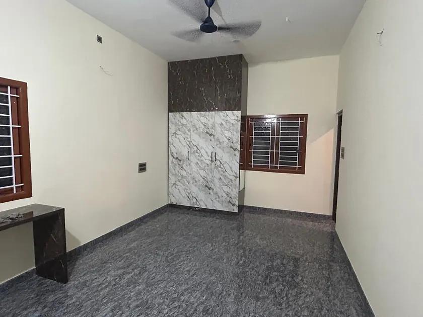 Bedroom with marble feature wall, window seat and polished floor