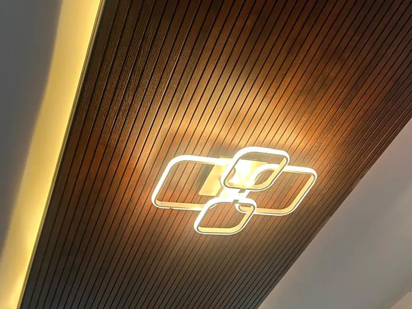 Fluted timber ceiling panel with a recessed decorative light fitting