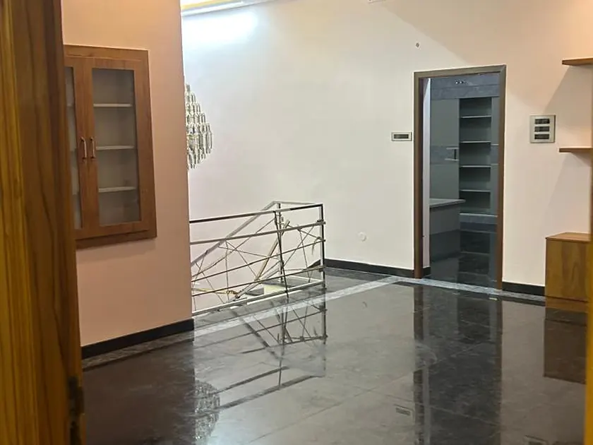 Entrance hall with polished floor, moulded cornice and staircase beyond