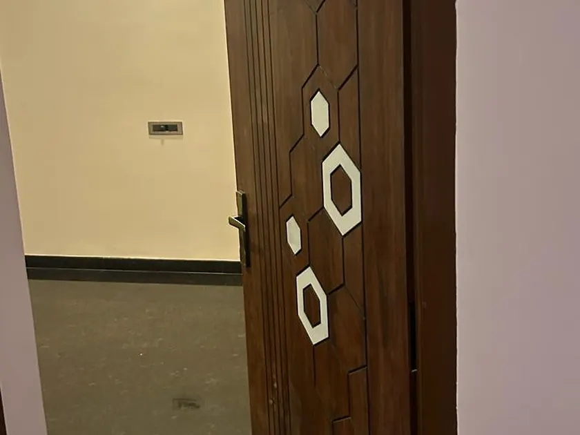 Solid timber main door with inlaid circular detailing